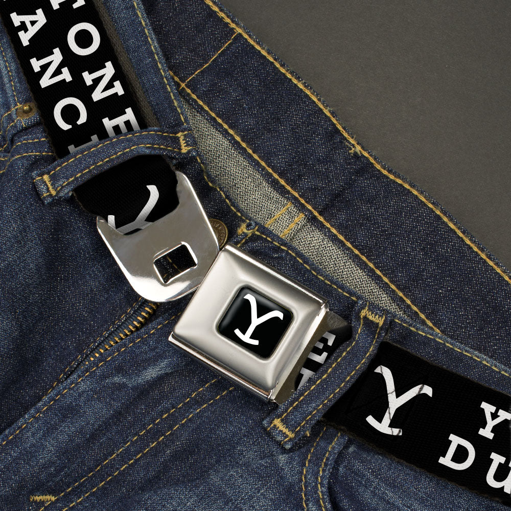 Close-up of the authentic push-button seatbelt buckle with Yellowstone logo